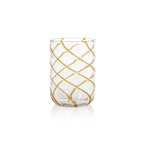 The AMBER SWIRL GLASS TUMBLER by ZODAX, a clear cylindrical glass adorned with bold gold diagonal swirl stripes, is elegantly displayed on a white background.