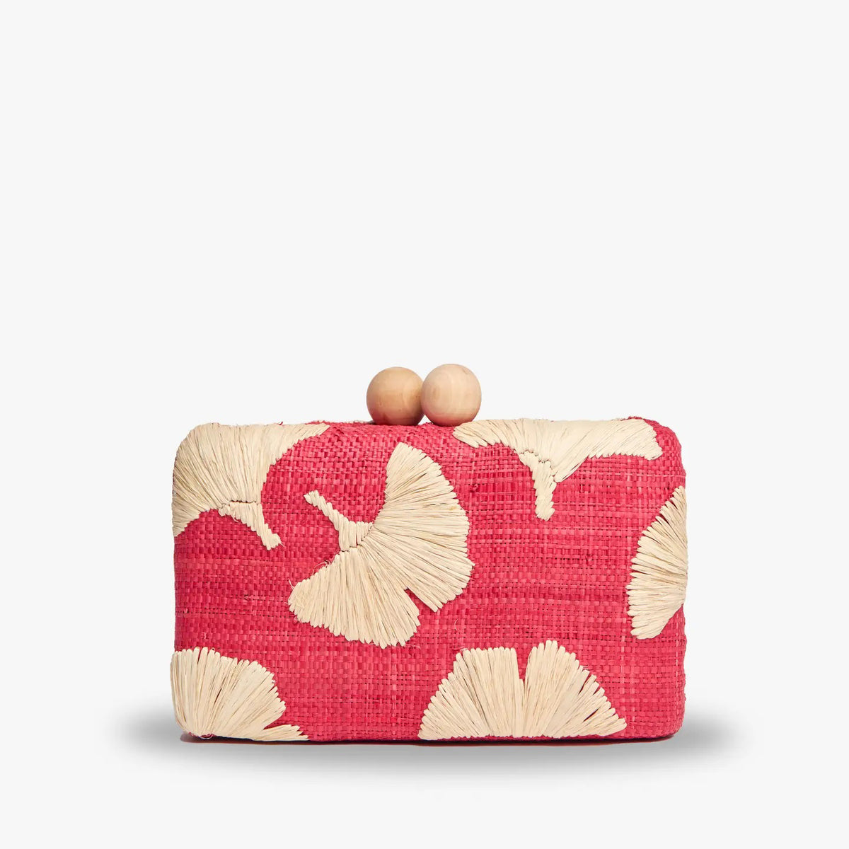 The KAYU AMI CLUTCH is a small pink raffia clutch with tan floral patterns, a beige interior, an optional gold chain strap, and a clasp featuring two wooden beads. The hand-embroidered charm is highlighted by the &quot;Kayu&quot; label inside.