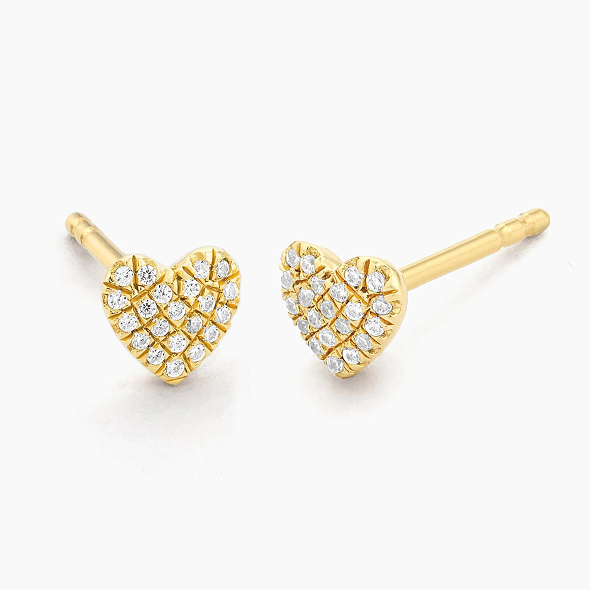 Presenting the ELLA STEIN Dome Heart Stud Earrings by ELLA STEIN—an elegant pair of gold-plated heart-shaped earrings, each adorned with a grid of small, sparkling diamonds, beautifully displayed against a white background.