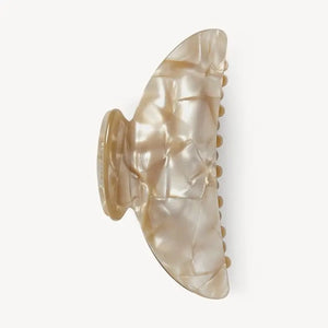 The MACHETE - MIDI HEIRLOOM CLAW by MACHETE is featured against a plain white background. This cream-colored hair accessory is crafted from luxurious Italian acetate and features curved edges with interlocking teeth, making it ideal for securing medium hair with effortless style.