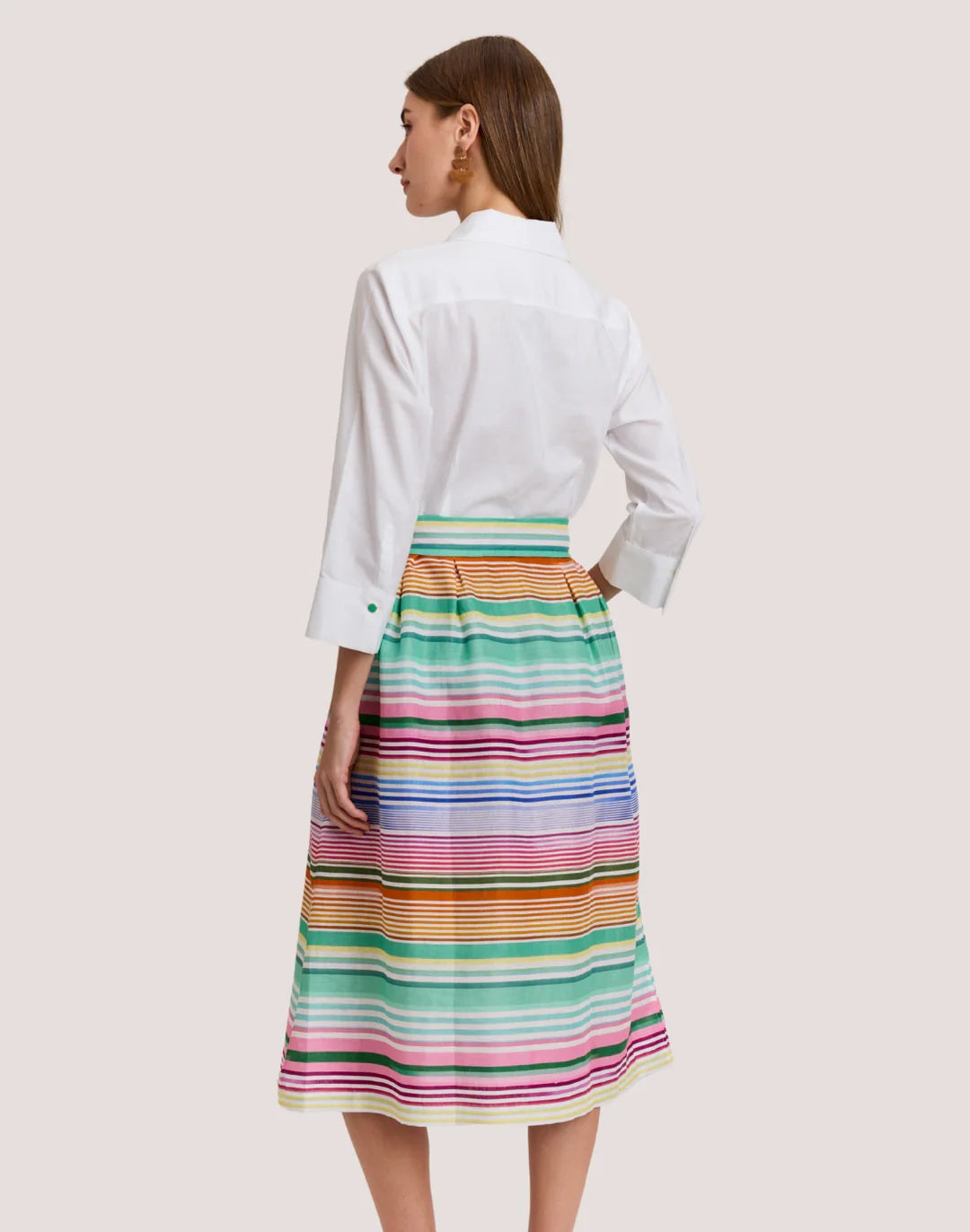 A woman wears the HINSON WU Robin 3/4 Sleeve Linen Dress in Multi Stripe, featuring breathable fabric and a matching tie belt, standing against a plain light background.