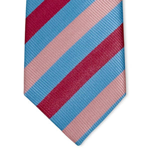 The PETER-BLAIR - CAGNEY WOVEN SILK TIE IN BLUE, PINK AND RED by BIRD DOG BAY features bold diagonal stripes, a subtle ribbed texture, and is handmade in New York for a sophisticated finish.