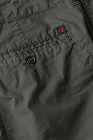 The RELWEN Flyweight Flex Chino in Charcoal, shown from the back with two buttoned pockets and subtle wrinkling, features a slim, straight-leg fit and lightweight stretch fabric for comfort. Pants are displayed flat on a white background.
