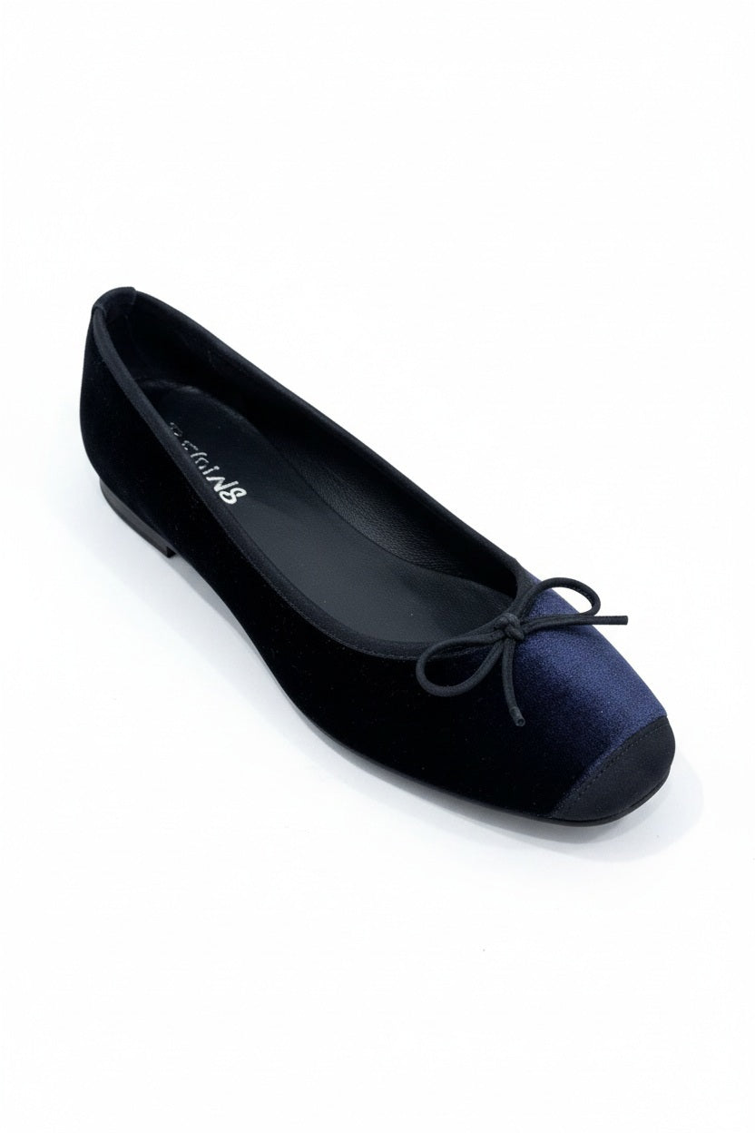 REQINS - HARMONY VELEVET BALLET FLATS IN NUIT, a dark blue velvet ballet flat featuring a small decorative bow at the toe and black trim for a classic feminine aesthetic.