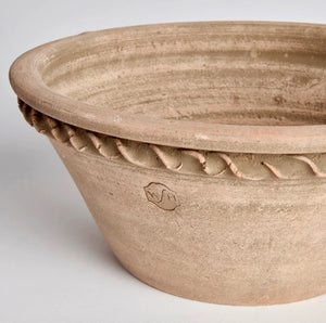 The NAPA HOME AND GARDEN - WAKEFIELD HENLEY FORCING POT is a round, shallow terracotta pot with a flared rim, rope-like edge detail, rough natural finish, and “Wakefield Handmade” stamped on the side.