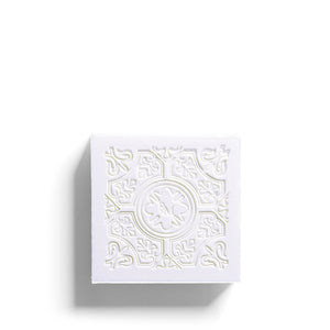 The ROSE ET MARIUS - A SUMMER NIGHT UNDER THE FIG TREE Scented Solid Soap Gift Box features a decorative box with floral patterns and two intricately designed cream-colored natural soaps inside, resting on a light gray interior.