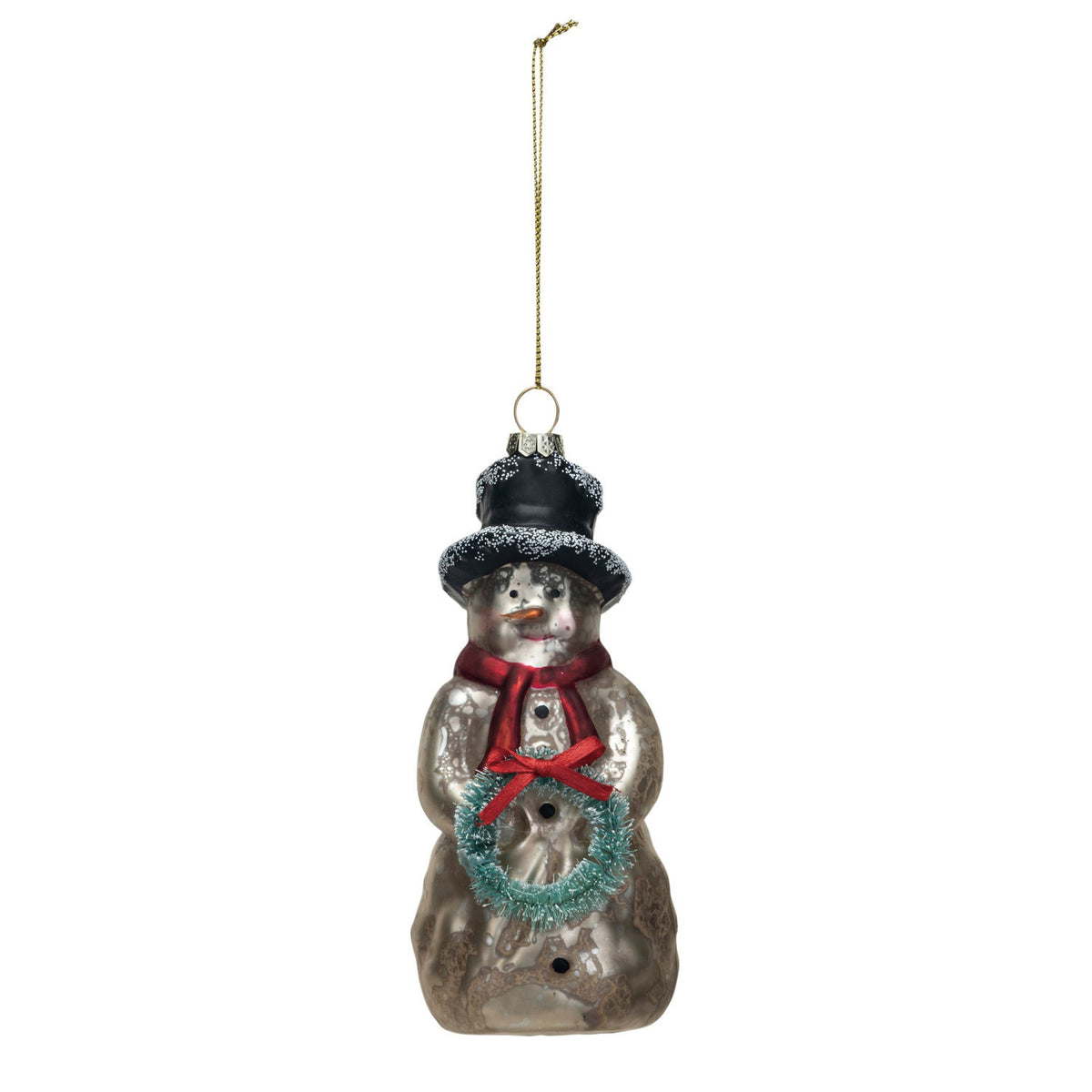 The CREATIVE COOP MERCURY GLASS SNOWMAN ORNAMENT, featuring a black hat, red scarf, and turquoise wreath, hangs on a textured white wall with a piece of rough-edged paper behind it.
