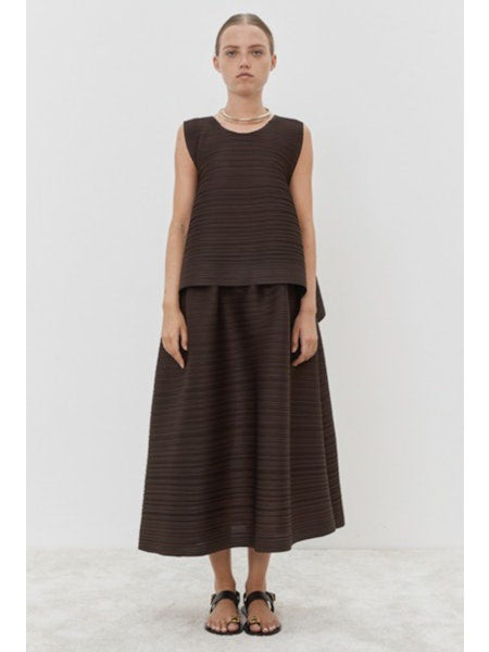 Close-up of MEIMEIJ - PLISSE SKIRT by MEIMEIJ, featuring a textured black fabric with an architectural fine weave pattern.