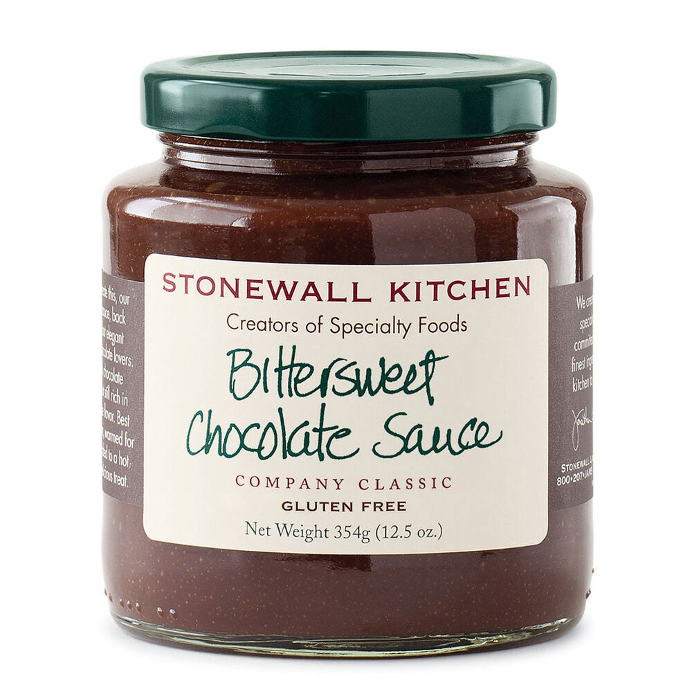 A jar of STONEWALL KITCHEN- BITTERSWEET CHOCOLATE SAUCE featuring a dark green lid promises a rich chocolate flavor. The label clearly states that it is gluten-free and weighs 354g (12.5 oz.). This hot fudge sauce is described as a classic from the brand, making it ideal for any dessert indulgence.
