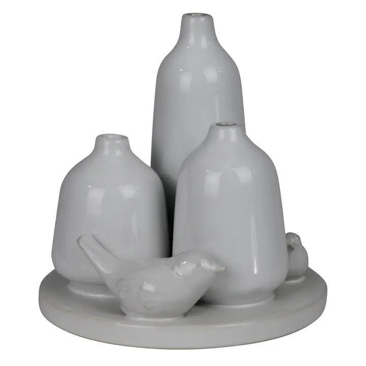 The HOMART CERAMIC VASE TRIO WITH TWO BIRDS features three matte white minimalist vases of varying heights and two bird figurines on a 5.5-inch round base; tallest vase stands 5 inches—ideal for bird vase decor.