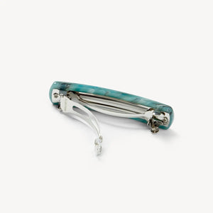 The MACHETE - NO. 3 Heirloom Barrette in Jadeite by MACHETE features a rectangular, rounded-edge handmade design in marbled blue-green cellulose acetate with white streaks, shown on a plain white background.