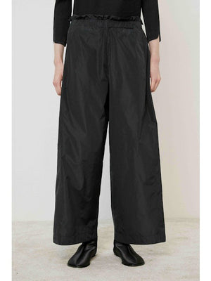 A flat, solid brown surface fills most of the image with a narrow black strip along the bottom edge, evoking the minimalist style of the MEIMEIJ - WIDE LEG PANT by MEIMEIJ.