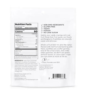 A 5.3oz bag of SIMPLY GUM - REALLY REAL PEACH RASPBERRY GUMMIES features images of raspberries, peach slices, and gummy candies on a white background. The packaging highlights non-GMO and plant-based qualities, is made with real fruit, and contains no artificial flavors.