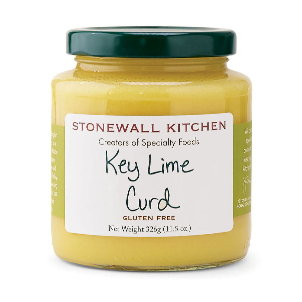 A jar of STONEWALL KITCHEN - KEY LIME CURD is shown. The label indicates it is gluten-free with a net weight of 326 grams (11.5 ounces). The jar, topped with a green lid, displays "Creators of Specialty Foods" above the product name. This English spread offers a tart flavor perfect for desserts and pastries.