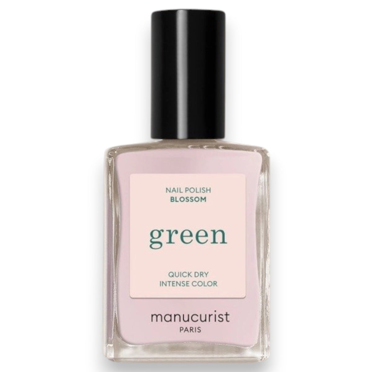 A hand with pale pink polished nails holds a bottle of MANUCURIST INC GREEN™ Nail Polish in Blossom against a gray knit sweater background.