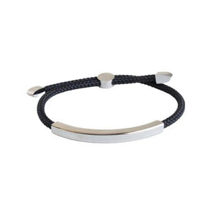 The STOLEN RICHES Algarve Bracelet in black features a braided cord with a sleek silver bar, silver end caps, and an adjustable sliding clasp for a minimalist look.