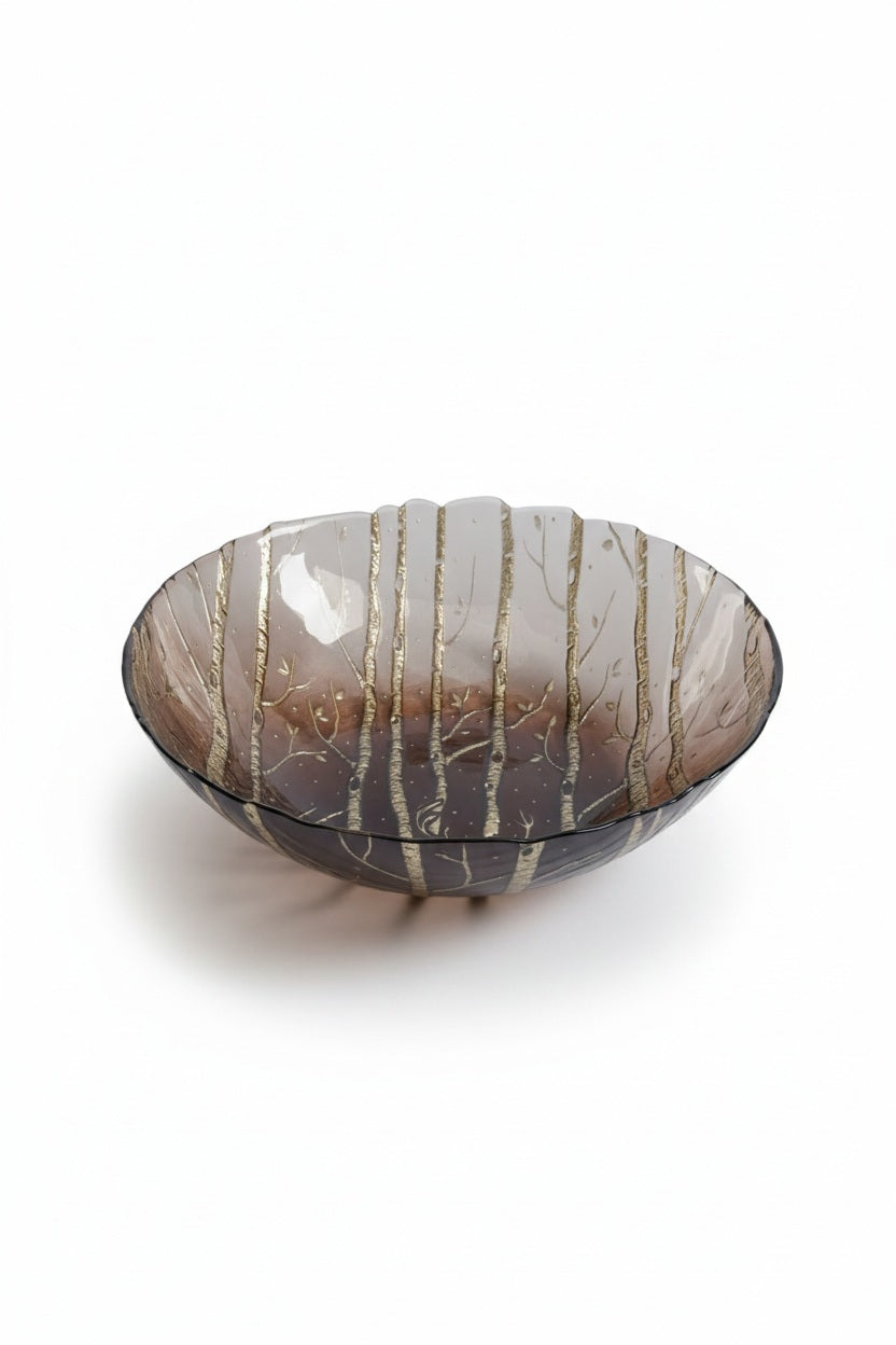 An 8.5-inch translucent brown ZODAX WILDERNESS SERVING BOWL IN TAUPE AND GOLD with a decorative gold forest pattern.
