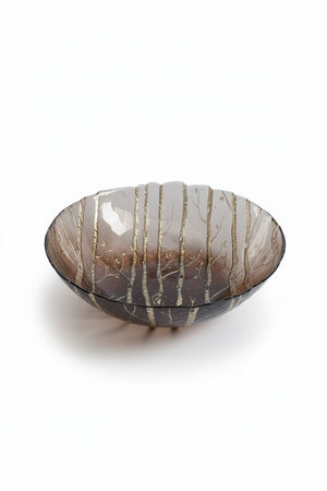 An 8.5-inch translucent brown ZODAX WILDERNESS SERVING BOWL IN TAUPE AND GOLD with a decorative gold forest pattern.