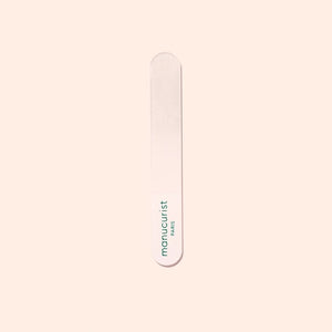 The MANUCURIST - GLASS BUFFER by MANUCURIST INC, shown alongside its rectangular light pink box with green text, is a recyclable premium nail buffer that delivers a flawless, polished-free shine.