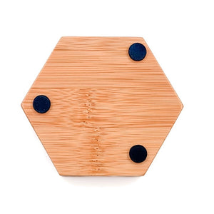 The BAUDELAIRE - BAMBOO HEX SOAP DISH is a hexagonal bamboo soap dish with horizontal grooves and the word “BAUDELAIRE” engraved on the front. Featuring a natural finish, this eco-friendly accessory brings both style and function to your bathroom sink or shower.