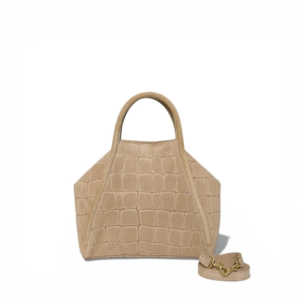 The OLIVEVE Taya Top Handle Crossbody in Ecru Italian Croco-Embossed Suede is a beige geometric handbag featuring top handles and a detachable crossbody strap with gold chain accents, crafted from luxurious Italian croco-embossed suede by OLIVEVE, and showcased against a plain white background.