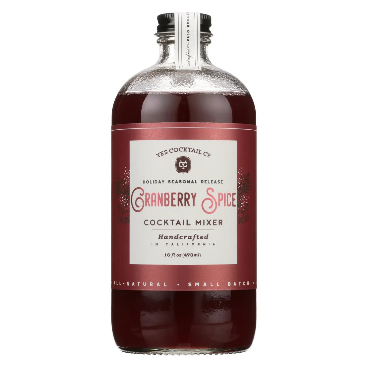 A clear bottle of YES COCKTAIL CO. - CRANBERRY SPICE COCKTAIL MIXER with a red label and silver cap contains 16 fl oz (473 ml) of this all-natural, handcrafted mixer—perfect for festive holiday celebrations.