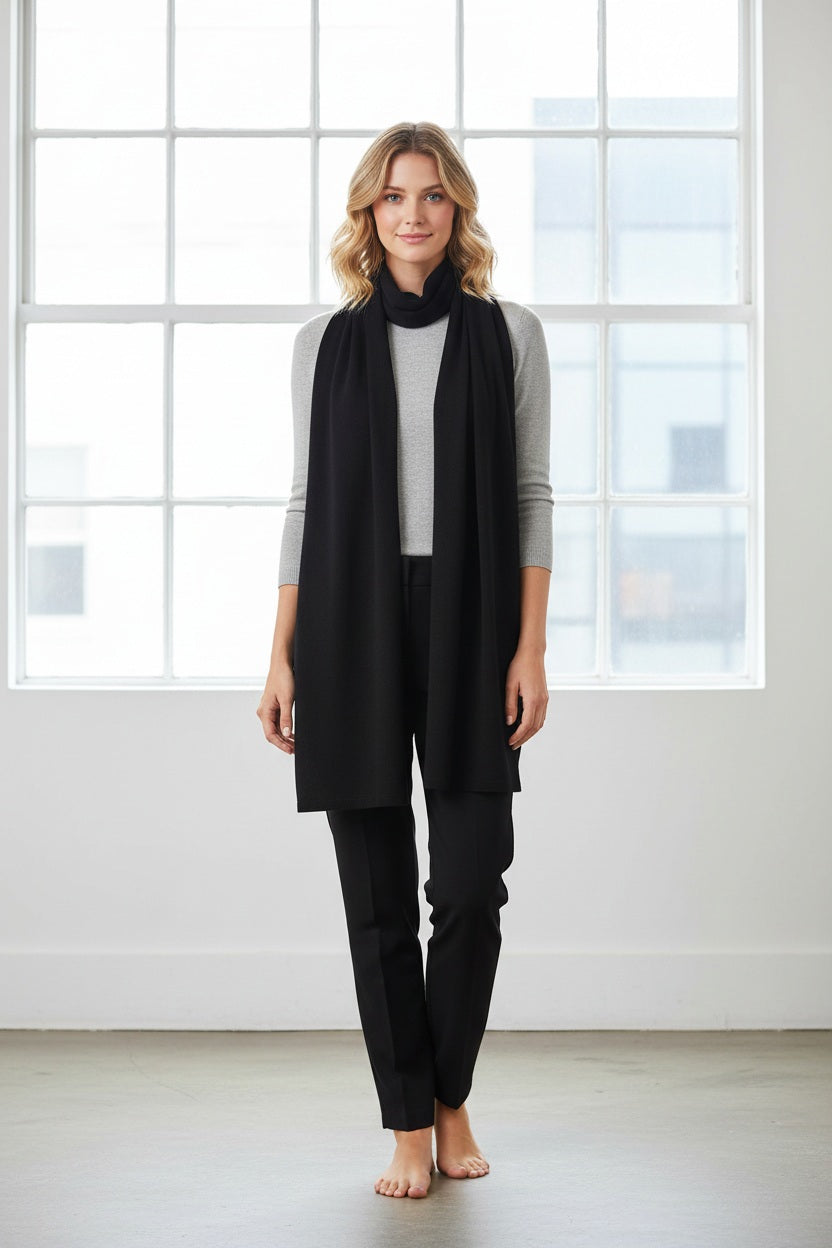 A woman with long, wavy blonde hair displays the drape and texture of the KINROSS CASHMERE Linen Lurex Wrap in light beige while wearing white pants against a plain white background.