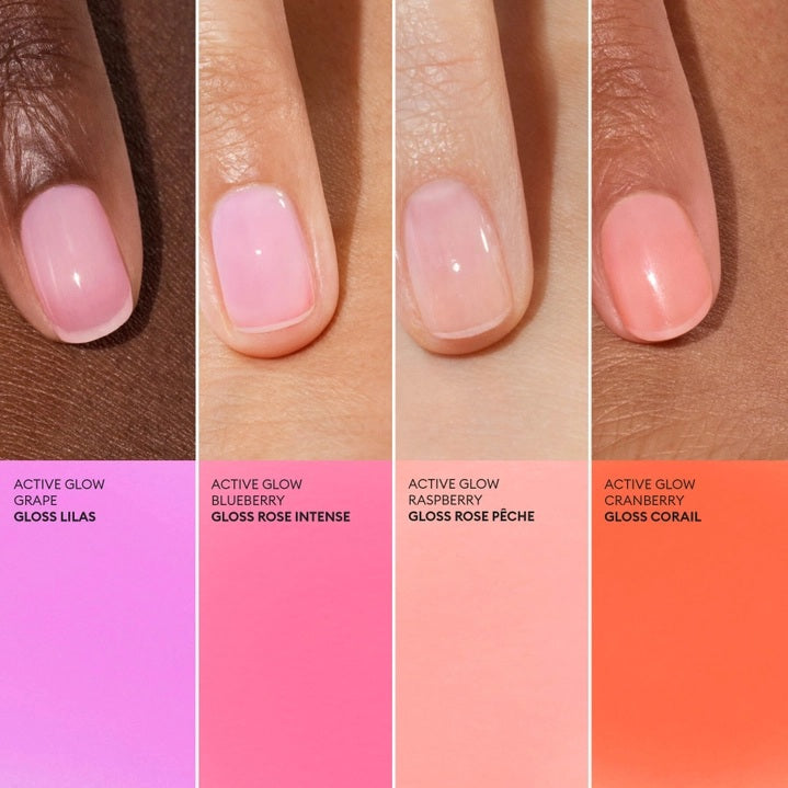 A pink serum drop labeled with its ingredients: raspberry extract (strengthens nails), AHAs (restore and harden), and sweet almond oil (nourishes). The text highlights that MANUCURIST - ACTIVE GLOW CARE POLISH by MANUCURIST INC is 85.5% plant-based—making it the ideal nail strengthener for achieving healthy, glass-like nails.