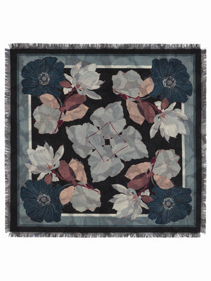 The FRANCO FERRARI - GRIDO REVERSIBLE WOOL SCARF 68X68 features a square shape, with blue, white, and mauve floral patterns on black, fringed edges, and detailed flowers and leaves at the corners and borders.