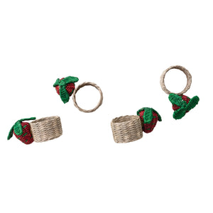 The CREATIVE COOP HAND-WOVEN SEAGRASS STRAWBERRY NAPKIN RINGS, SET OF 4, feature red and green strawberry accents and are displayed on a white background.
