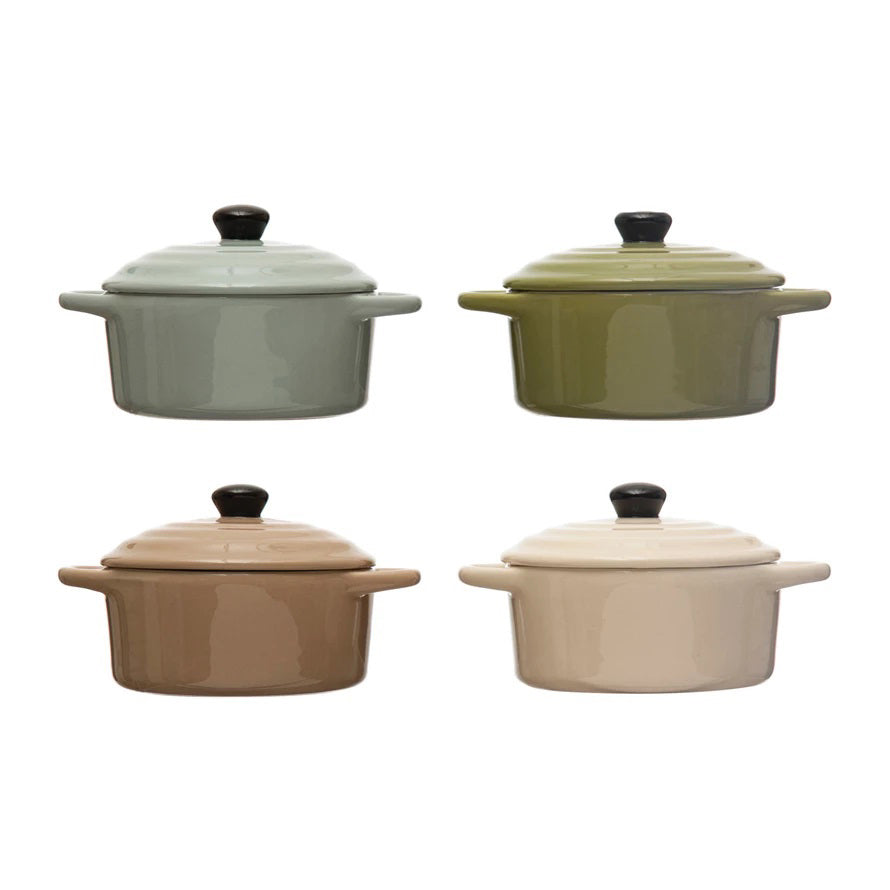 Four &quot;1 CUP MINI BAKER WITH LID&quot; casserole dishes by CREATIVE COOP are arranged in a 2x2 grid. The top left is light blue, the top right is olive green, the bottom left is light brown, and the bottom right is beige. Each piece of this versatile bakeware features a black knob on its lid.