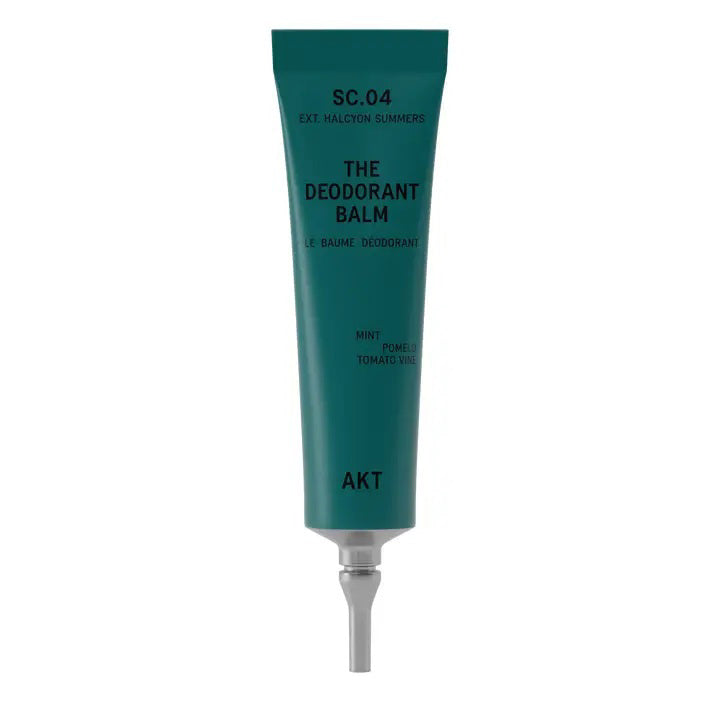 The AKT LONDON AKT DEODORANT BALM HALCYON SUMMERS, in a green tube with a silver cap, offers all-day protection using natural plant and mineral powders and features a mint, pomelo, and tomato vine scent.