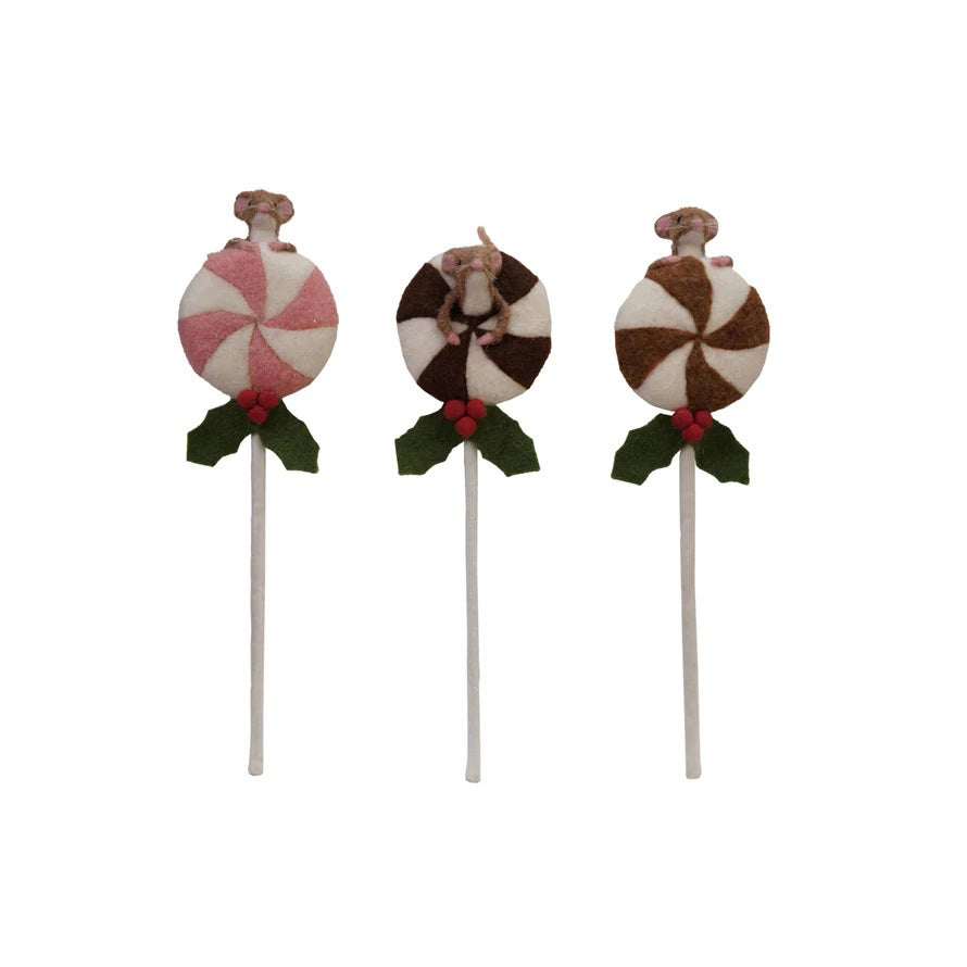 The CREATIVE COOP HANDMADE FELT LOLLIPOP WITH MOUSE features three wool felt lollipops topped with small felt mice, red holly berries, and green leaves in brown/white, tan/white, and pink/white swirls on a light background.