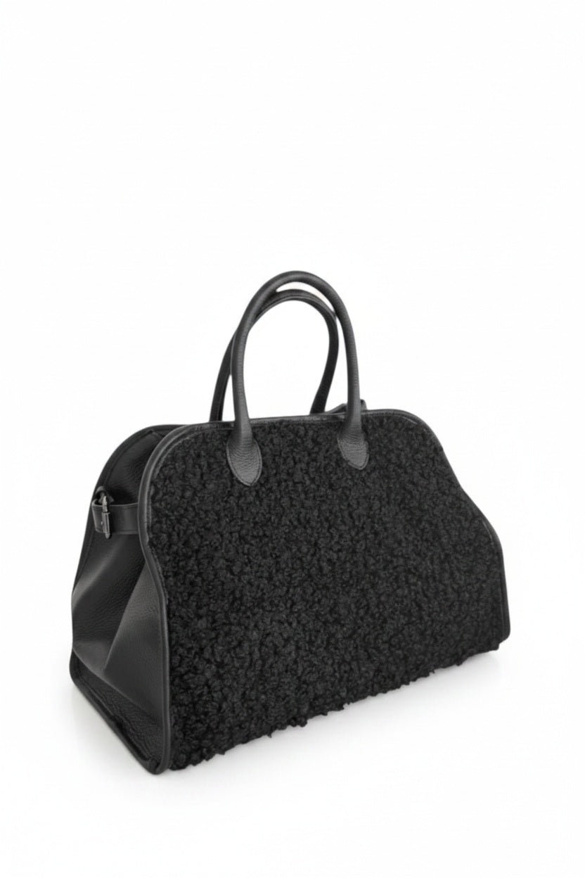 The VICARIO CINQUE - BORUSSIA HANDBAG by VICARIO CINQUE is shown on a white background, featuring a black bouclé-textured exterior on the sides and smooth leather handles.