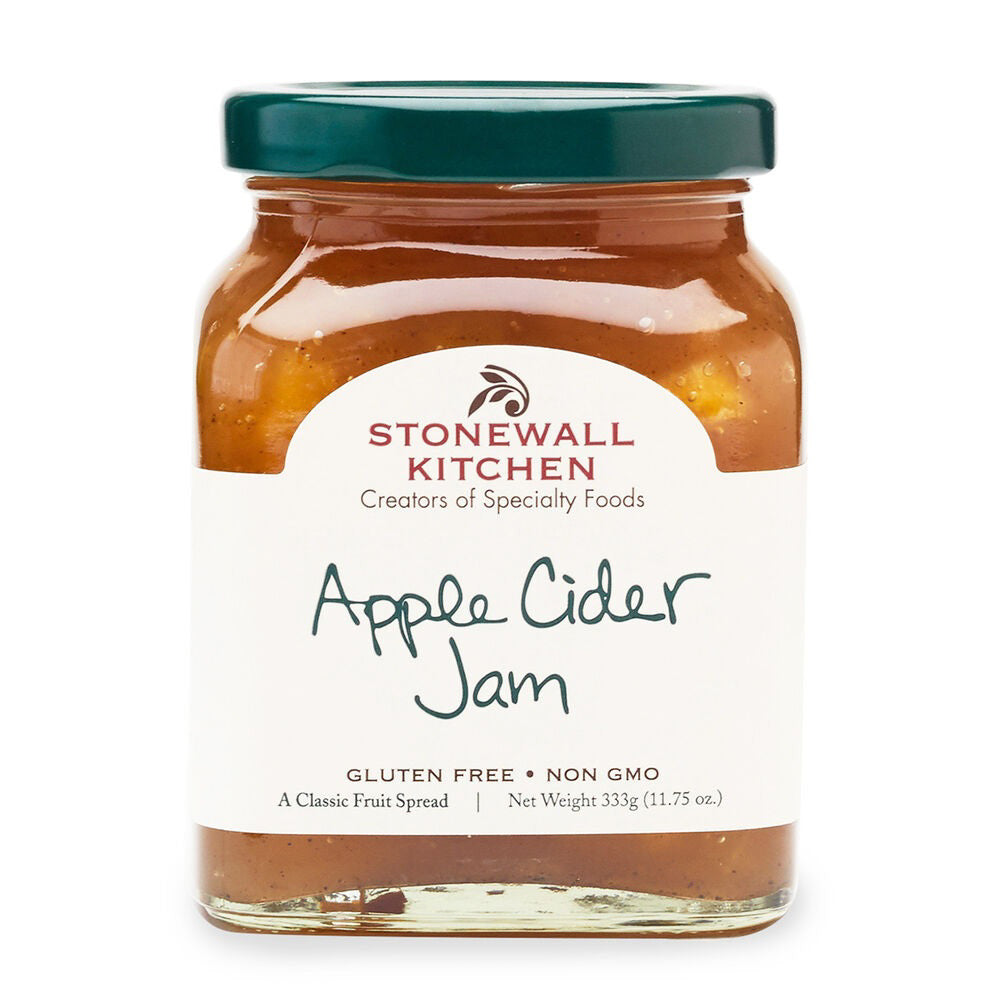A jar of STONEWALL KITCHEN Apple Cider Jam is displayed. The label indicates it is gluten-free, non-GMO, and a classic fruit spread with tart apple cider and aromatic spices. The net weight is 333g (11.75 oz.). The jar has a green lid, and the branding on the label includes "Creators of Specialty Foods.