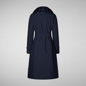 The SAVE THE DUCK GABRIELLE LONG SLEEVE COAT, a navy blue, water-resistant trench with a belted waist, matching buttons, and quilted hood and cuffs from SAVE THE DUCK, is shown on a plain light gray background.