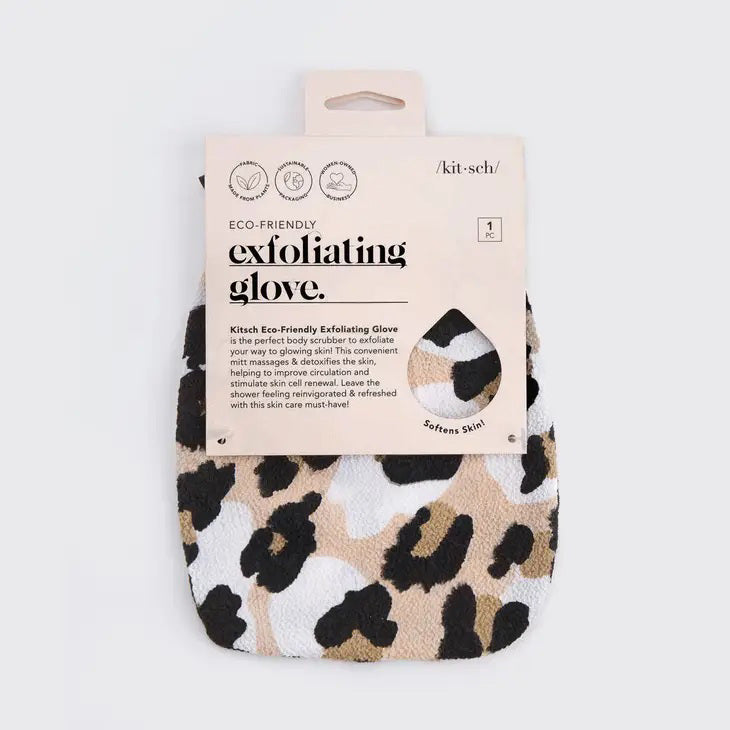 The KITSCH Eco-Friendly Exfoliating Glove boasts a leopard print with black spots on a beige and white background, designed perfectly for bath or shower scrubbing. It features a convenient black tag with white text at the top.