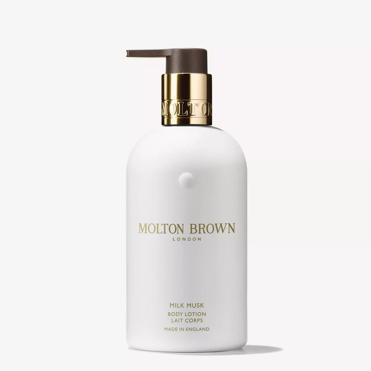 A white bottle of MOLTON BROWN - MILK MUSK BODY LOTION with a gold and brown pump and gold lettering, shown on a white background—a moisturizing lotion with a subtle floral musk scent from MOLTON BROWN.