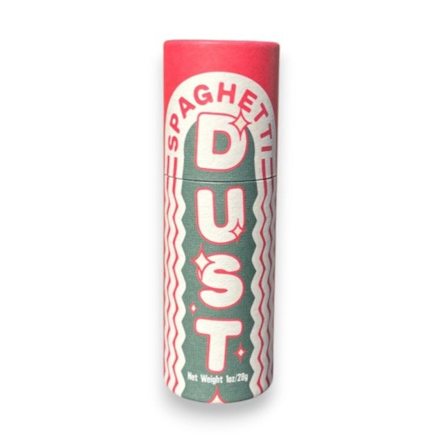 A cylindrical container of L'ISOLINA PASTA - SPAGHETTI DUST from L’ISOLINA PASTA stands upright, with a small pile of colorful Italian pasta spice flakes nearby on a light background.