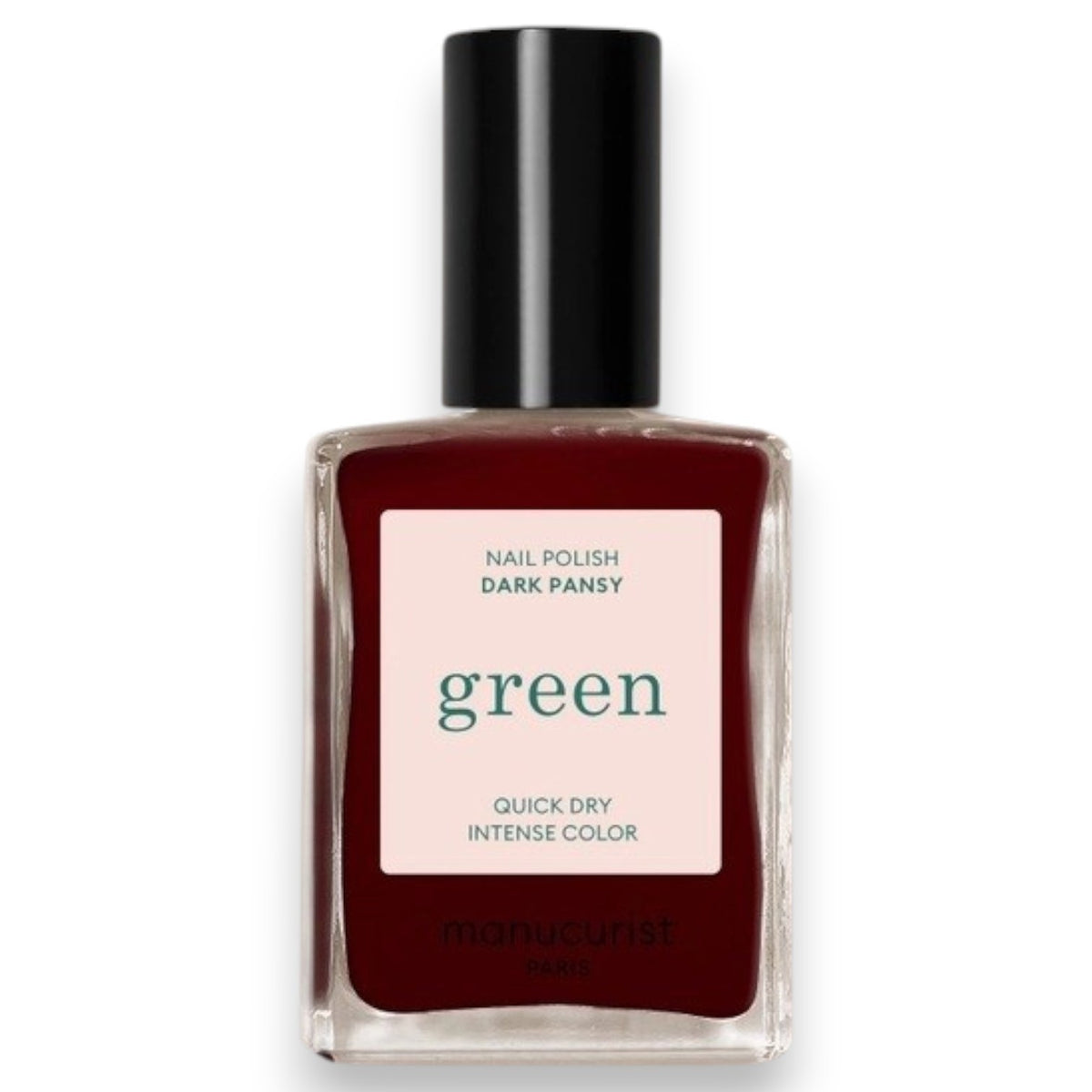 A hand with neatly manicured nails painted in a rich shade of dark red rests on red fabric beside a matching bottle of MANUCURIST INC’s GREEN™ Nail Polish in Dark Pansy, a non-toxic and vegan formula.