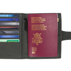 The GARZINI RFID-blocking leather passport holder in Carbon Black features multiple card slots, a pen holder, angled pockets, a transparent ID window, an Airtag compartment, and a snap-button closure flap.