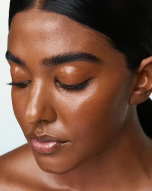 A 30 ml (1.0 fl oz) bottle of U BEAUTY - THE SUPER TINTED HYDRATOR SHADE 10, a dewy skin tint and moisturizer, stands upright with a white cap and frosted body against a light grey background.