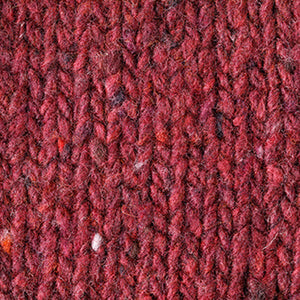 Close-up of the BASE MILANO - HEATHERED CREWNECK SWEATER, a textured, hand-knitted deep red virgin wool piece with multicolored flecks. Made in Italy by BASE MILANO.