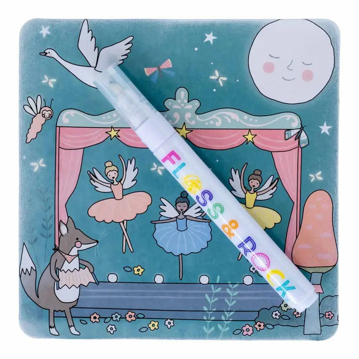 A colorful, fairy-tale-themed illustration shows a stage with dancing ballerina fairies, a smiling moon, and a fox in a dress. A white pen labeled "FLOSS &amp; ROCK" lies diagonally across the image. This travel-friendly toy, known as the FLOSS AND ROCK - ENCHANTED WATER PENS AND CARDS, includes reusable water cards adorned with stars and whimsical designs.