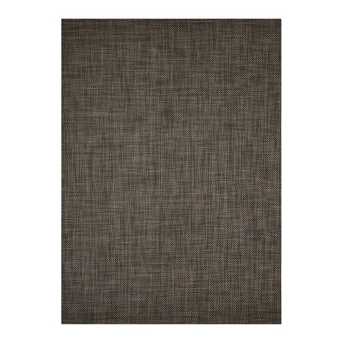 A wooden chair with a woven seat and simple backrest sits on the CHILEWICH - BASKETWEAVE FLOORMAT by CHILEWICH, made with recycled content, set against a plain white wall with white baseboards.