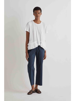 Someone wearing MEIMEIJ Pull On Cotton Pant in Black, a white top, and black open-toe sandals stands against a plain light background.