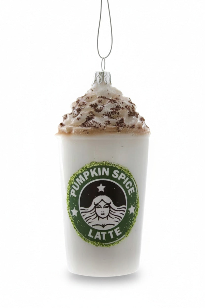 A 4-inch Cody Foster PUMPKIN SPICE LATTE ORNAMENT shaped like a white coffee cup topped with whipped cream, featuring a circular green logo with the words “PUMPKIN SPICE LATTE.”.