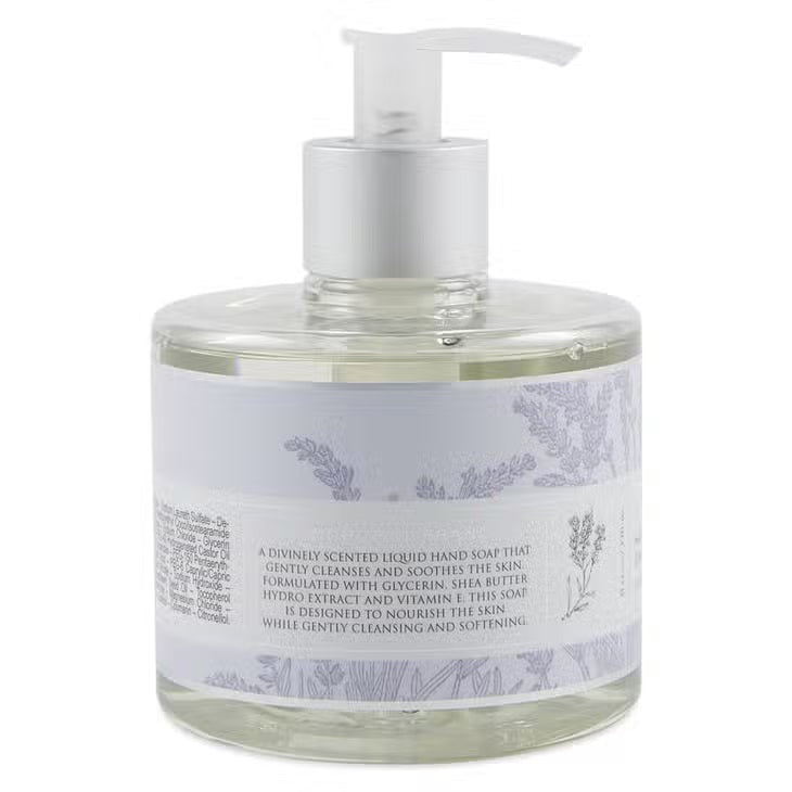 A clear pump bottle labeled "EUROPEAN SOAPS, LLC" contains lavender-scented HERITAGE LIQUID SOAP enriched with glycerin. The label features lavender plant illustrations and text in both English and French. The light purple liquid soap inside adds to the packaging's elegant and minimalistic appeal.