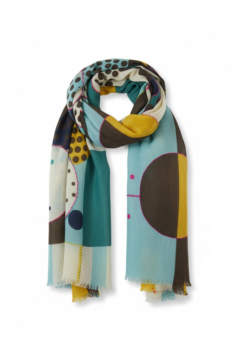 Introducing the STORIATIPIC - BAO Wool Scarf with Embroidery in Blue by STORIATIPIC: a generously sized (100 x 200 cm) wool scarf featuring a modern geometric pattern in teal, mustard yellow, brown, black, and white. Adorned with embroidered circles, dots, and rectangular motifs for a soft texture, this lightweight accessory is finished with frayed edges for added style.