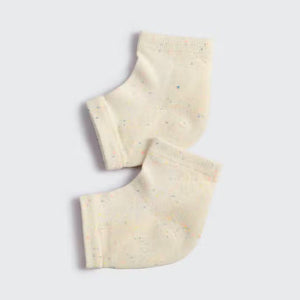 Displayed against a plain background are two light beige KITSCH - MOISTURIZING HEEL SOCKS with subtle multicolored speckles. They feature an insulated gel lining, positioned side by side to show their knit texture, promising to hydrate and soften your skin.